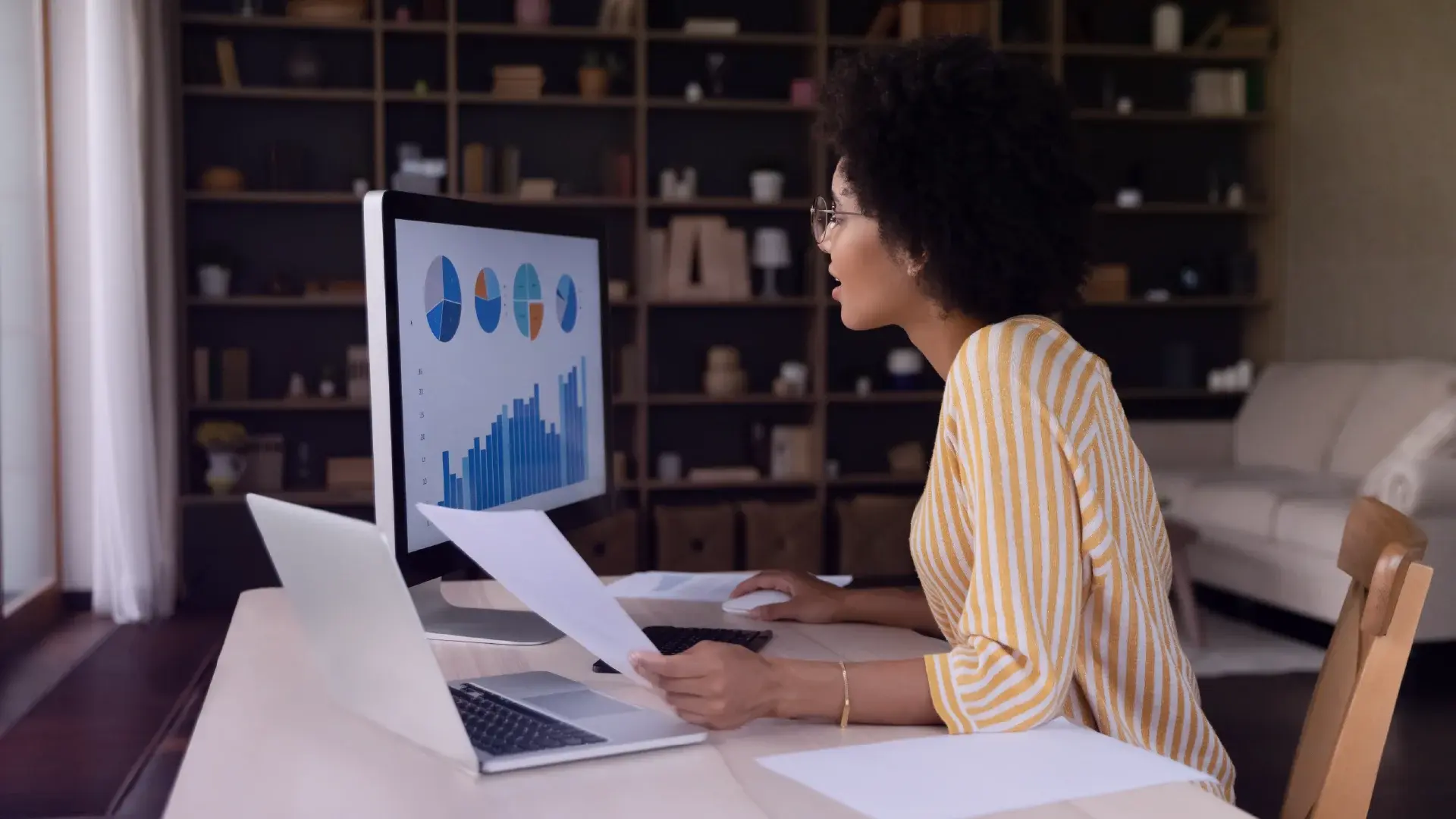 A woman looking at graphs on a computer